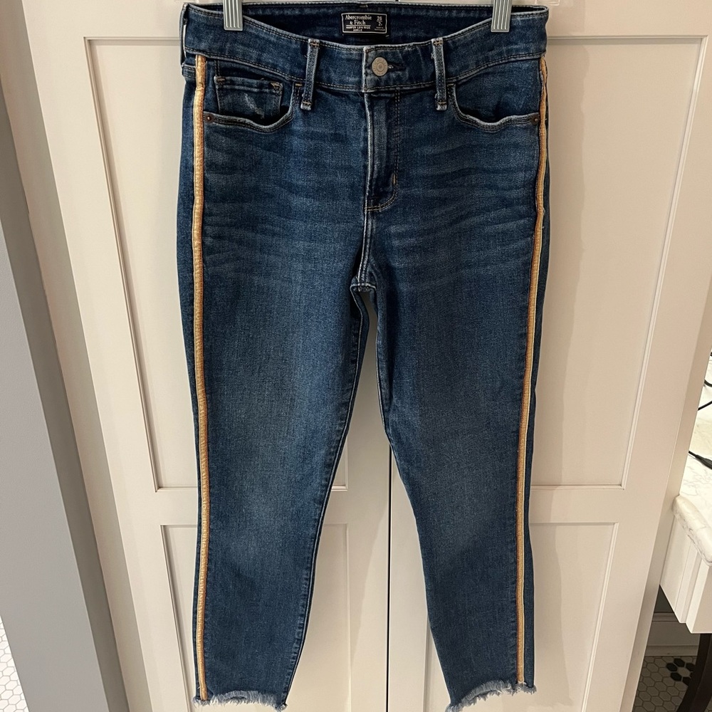 Abercrombie Low Rise jeans with frayed ankles and yellow ribbon